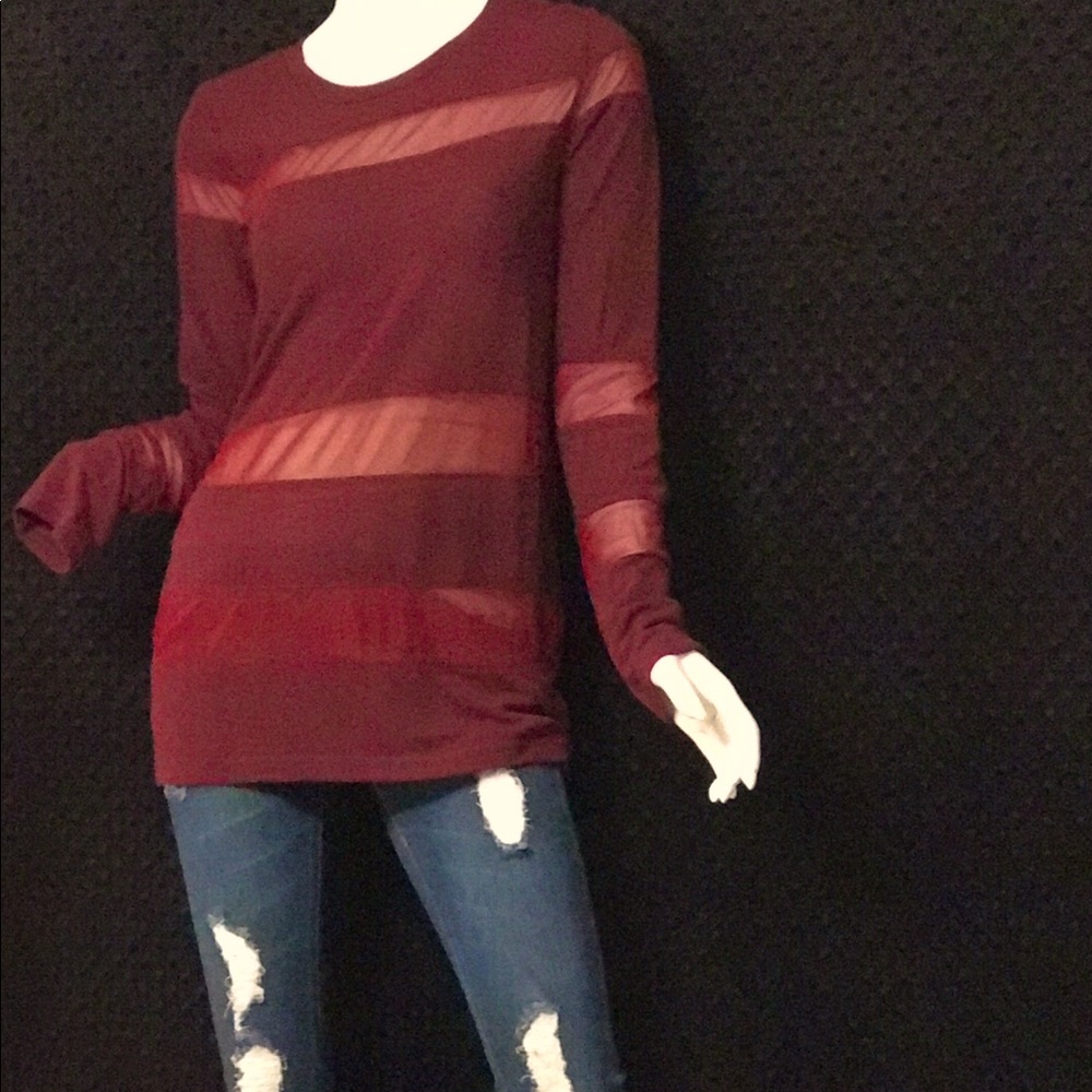 Brand new maroon top with mesh cut outs. Brand new from my boutique. Very sleek